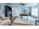 Cozy home office space with wood floors, large bookshelf, and comfortable seating area at 6105 Overlook Park Dr, Cumming, GA 30040