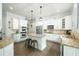 Modern kitchen with white cabinetry, stainless steel appliances, granite counters, and kitchen island at 6105 Overlook Park Dr, Cumming, GA 30040