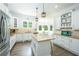 Bright kitchen with white cabinetry, stainless steel appliances, granite countertops, and hardwood floors at 6105 Overlook Park Dr, Cumming, GA 30040