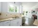 Kitchen featuring white cabinets, stainless steel appliances and granite countertops at 6105 Overlook Park Dr, Cumming, GA 30040