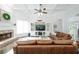 Spacious living room with coffered ceiling, brick fireplace, and built-in entertainment center at 6105 Overlook Park Dr, Cumming, GA 30040