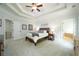 Spacious main bedroom with neutral tones, and a sitting area at 6105 Overlook Park Dr, Cumming, GA 30040