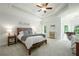 Main bedroom featuring a trey ceiling, neutral tones, and a sitting area at 6105 Overlook Park Dr, Cumming, GA 30040