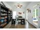 Bright home office with hardwood floors, built-in bookcase, and access to the front porch at 6105 Overlook Park Dr, Cumming, GA 30040