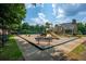 Community playground with slides, swings, and benches, adjacent to a covered picnic area at 6105 Overlook Park Dr, Cumming, GA 30040