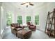 Sitting area with brown leather chairs and natural light at 6105 Overlook Park Dr, Cumming, GA 30040