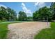 A sandy volleyball court with a net, basketball court, and mature trees is available for community enjoyment at 6105 Overlook Park Dr, Cumming, GA 30040