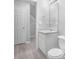 Bathroom featuring a toilet, sink, vanity, a mirror, with a door to the left at 6947 Gallant Se Cir # 10, Mableton, GA 30126