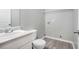 Bathroom featuring a toilet, sink, mirror, a shelf and washer/dryer hookups at 6947 Gallant Se Cir # 10, Mableton, GA 30126