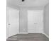 Bedroom featuring light gray walls, light gray flooring and two white doors at 6947 Gallant Se Cir # 10, Mableton, GA 30126