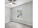 Bedroom featuring light gray walls, a ceiling fan, light gray flooring, and a window at 6947 Gallant Se Cir # 10, Mableton, GA 30126