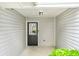 A classic black front door is set against light gray vinyl siding at 6947 Gallant Se Cir # 10, Mableton, GA 30126