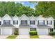 Attractive townhome showcasing curb appeal with a well-manicured lawn, garage, and charming details at 6947 Gallant Se Cir # 10, Mableton, GA 30126