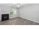 A well lit living room is anchored by a fireplace and has wide plank flooring at 6947 Gallant Se Cir # 10, Mableton, GA 30126