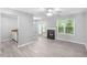 An open-concept living space connects to the kitchen, doors, a fireplace, and a window at 6947 Gallant Se Cir # 10, Mableton, GA 30126