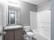 Bathroom featuring a tub with shower, gray vanity, and tile flooring at 7432 Battlecreek Ln, Jonesboro, GA 30236