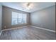 Bright bedroom with neutral walls, modern flooring, and a large window at 7432 Battlecreek Ln, Jonesboro, GA 30236