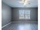 A spacious bedroom is enhanced by ample sunlight streaming through a large window at 7432 Battlecreek Ln, Jonesboro, GA 30236