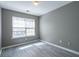 A bright bedroom is enhanced by ample sunlight streaming through a large window at 7432 Battlecreek Ln, Jonesboro, GA 30236