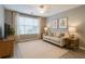 Comfortable living room with neutral decor, plush sofa, and ample natural light at 7432 Battlecreek Ln, Jonesboro, GA 30236
