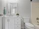 Traditional bathroom with modern vanity, decorative mirror, and a combined shower and bathtub at 206 Five Iron Nw Ct, Kennesaw, GA 30144
