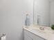 Bright bathroom featuring a single sink vanity with modern faucet, ample countertop space, and a large mirror at 206 Five Iron Nw Ct, Kennesaw, GA 30144