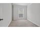 The bedroom features neutral paint and carpet, crown molding, and a large window at 206 Five Iron Nw Ct, Kennesaw, GA 30144