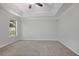 Spacious main bedroom features a ceiling fan, new carpet, and a window at 206 Five Iron Nw Ct, Kennesaw, GA 30144