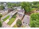 Aerial view of a home nestled in a vibrant neighborhood with mature trees, showcasing its covered porch and curb appeal at 218 South Se Ave, Atlanta, GA 30315