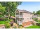 Aerial view of a two-story home with multi-level decks, a stone patio, a garden, and lush landscaping at 218 South Se Ave, Atlanta, GA 30315