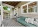 Relaxing back deck featuring a built-in bench seat with plush pillows, modern grill, and wood flooring at 218 South Se Ave, Atlanta, GA 30315