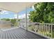 Cozy back porch with wood flooring, white railings, and views of the yard, perfect for relaxation and outdoor living at 218 South Se Ave, Atlanta, GA 30315