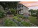 Tranquil backyard with a stone patio, manicured landscaping, raised garden beds, and a charming two-story home at 218 South Se Ave, Atlanta, GA 30315
