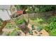 Aerial shot of a beautiful backyard with stone patio, outdoor seating, lush plants, and manicured lawn at 218 South Se Ave, Atlanta, GA 30315
