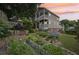 Landscaped backyard with a two-story home, featuring tiered gardens and double-decker porches perfect for outdoor living at 218 South Se Ave, Atlanta, GA 30315