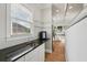 Stylish bar area with granite countertops, glass shelving, and a view of the kitchen at 218 South Se Ave, Atlanta, GA 30315