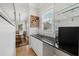 Elegant bar area with granite counter, wine rack, glass shelves, and view to dining room at 218 South Se Ave, Atlanta, GA 30315