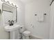 Clean bathroom features a sleek pedestal sink and modern fixtures at 218 South Se Ave, Atlanta, GA 30315