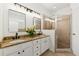 Bathroom with double vanity sinks, granite countertop, modern fixtures, and glass-enclosed shower at 218 South Se Ave, Atlanta, GA 30315