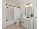 White bathroom features a shower with tile surround and a vanity with a black faucet at 218 South Se Ave, Atlanta, GA 30315