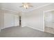 Bedroom with neutral paint and trim, ceiling fan and double closets at 218 South Se Ave, Atlanta, GA 30315