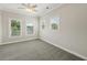 Spacious bedroom features a ceiling fan and three windows, with carpeting at 218 South Se Ave, Atlanta, GA 30315
