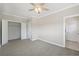 Spacious bedroom features a ceiling fan, and two doors, with a large closet space at 218 South Se Ave, Atlanta, GA 30315
