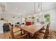 Open-concept living and dining area with rustic table, pendant lighting, and comfortable seating at 218 South Se Ave, Atlanta, GA 30315