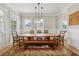 Dining room featuring a large wooden table, bench seating, and stylish pendant lighting at 218 South Se Ave, Atlanta, GA 30315
