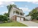 Inviting home with a covered porch, two-car garage, landscaped yard, and a stairway leading to the main entrance at 218 South Se Ave, Atlanta, GA 30315