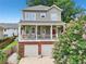 Charming two-story home featuring a welcoming front porch, red door, and a two-car garage at 218 South Se Ave, Atlanta, GA 30315