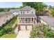 Charming two-story home featuring a covered porch, white railing, red door, and a two-car garage at 218 South Se Ave, Atlanta, GA 30315