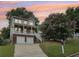Exterior shot of a two-story home with a charming front porch, brick foundation, and blooming tree at 218 South Se Ave, Atlanta, GA 30315