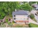 Aerial view showcasing the home's exterior, featuring a multi-level porch, lush landscaping, and a well-maintained yard at 218 South Se Ave, Atlanta, GA 30315